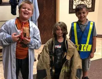 Three children dressed up in costumes for halloween.