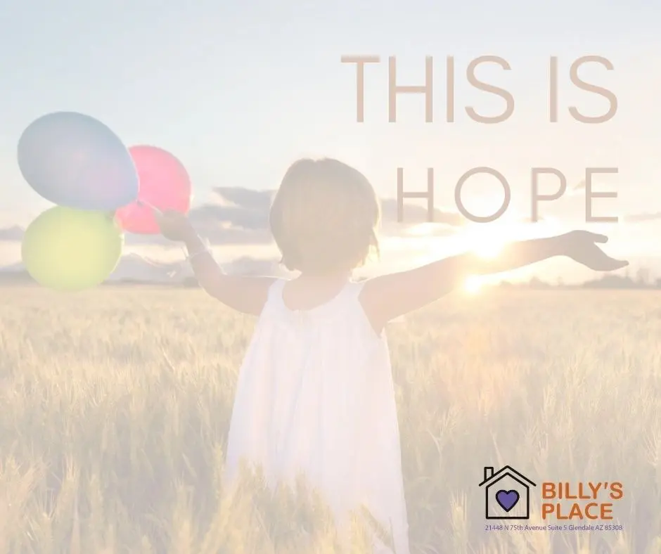 A young child in a white dress, arms spread wide, holding colorful balloons in a field at sunset, with text "this is hope" and a logo for "billy's place.