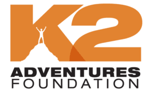 Logo of k2 adventures foundation featuring a stylized orange mountain peak