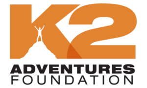 Logo of k2 adventures foundation featuring a stylized orange mountain peak